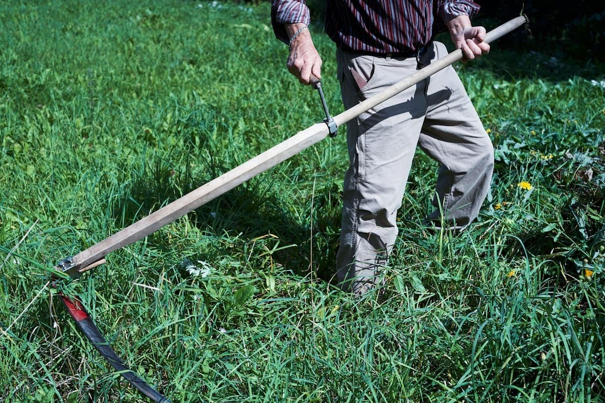 Lawn care operator checking Houseler on a phone in a work truck