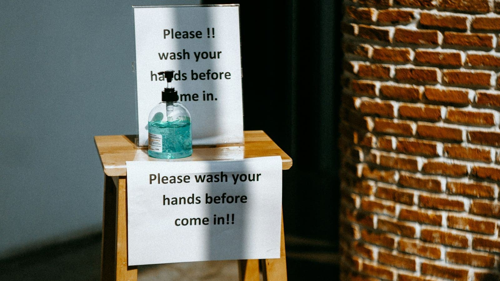 Pest control technician spraying the foundation of a residential home