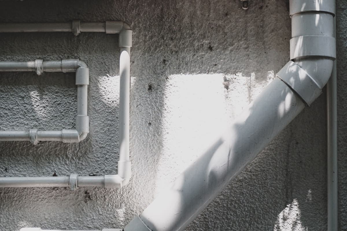 Plumber installing a water heater in a residential utility room