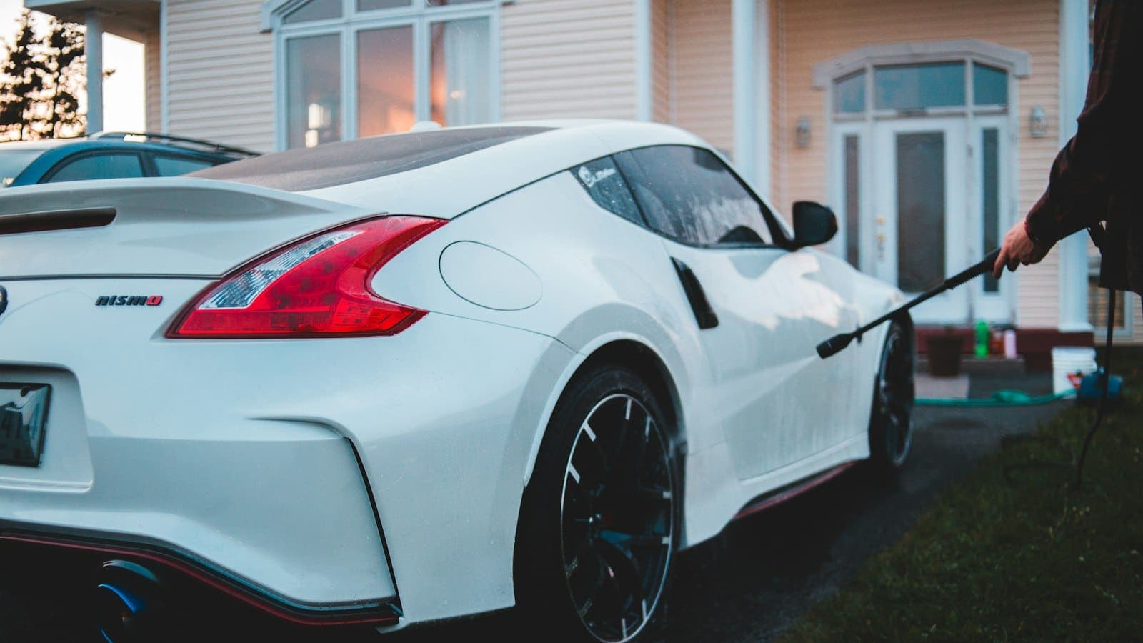 Pressure washer cleaning a residential driveway on a sunny day